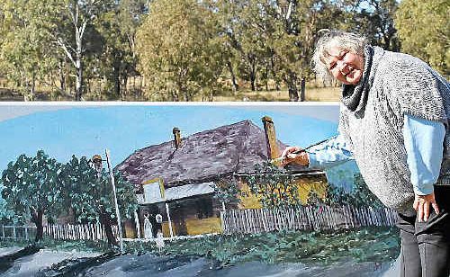 Elizabeth Young sketches out the next image she is painting on a safety barrier. Elizabeth Young sketches out the next image she is painting on a safety barrier.